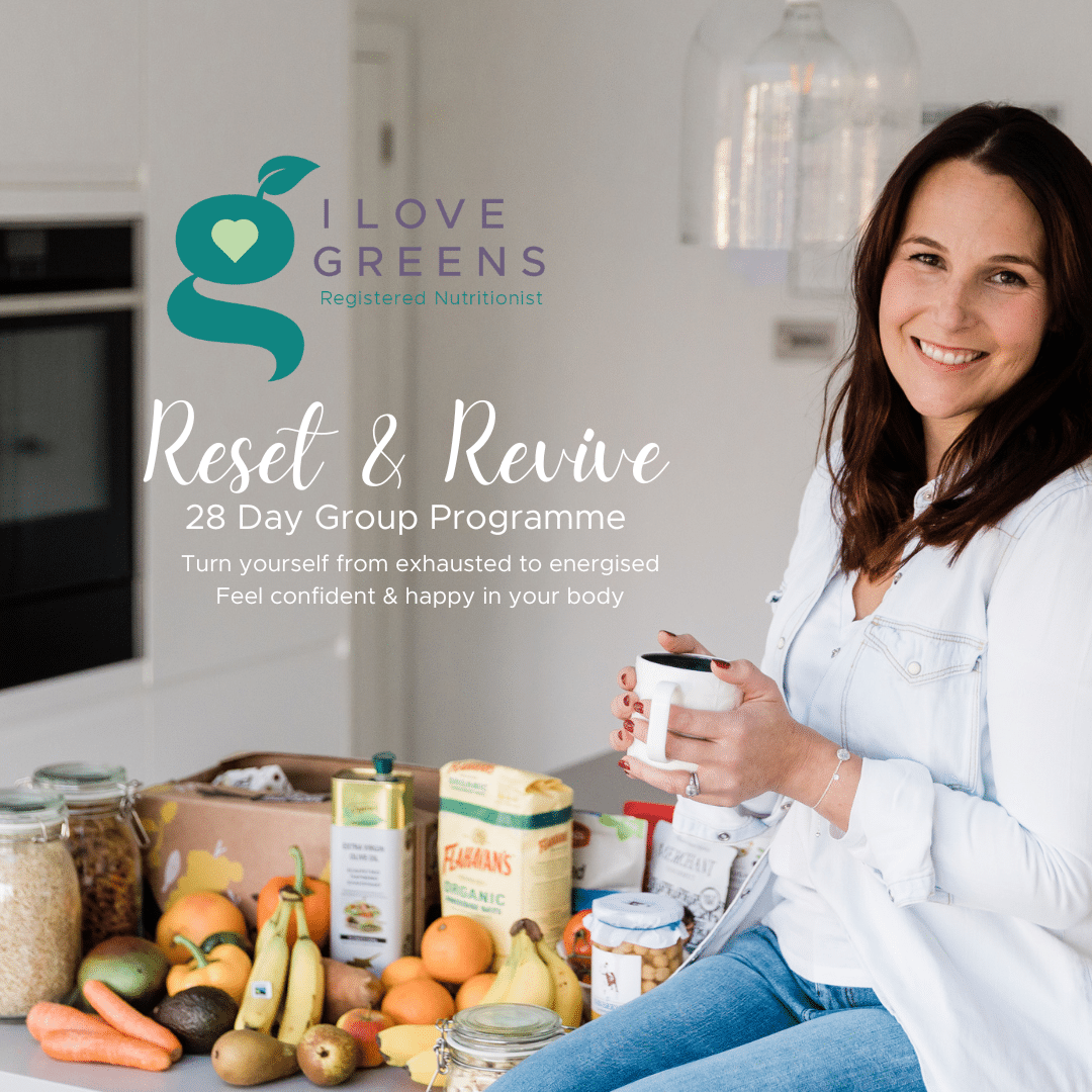 White woman, dark hair, sitting next to healthy food, holding mug. Text reads Reset & Revive