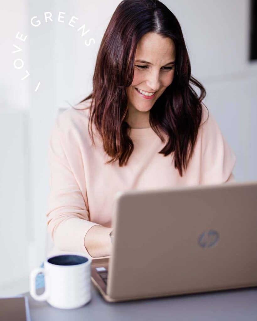 Workplace corporate wellness woman at desk with laptop and coffee working